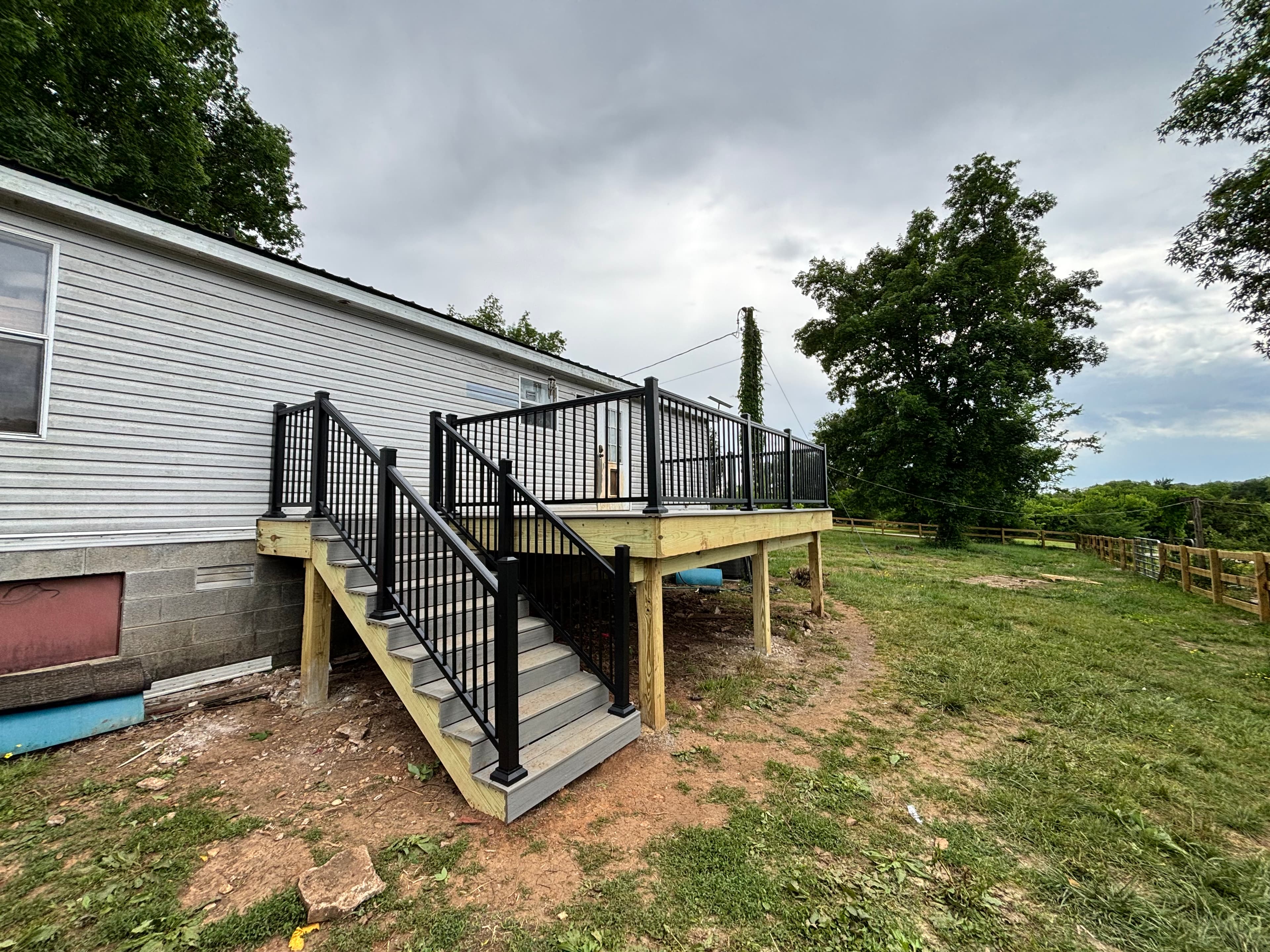 Composite deck with black aluminum railing and stairs on mobile home, Middle Tennessee