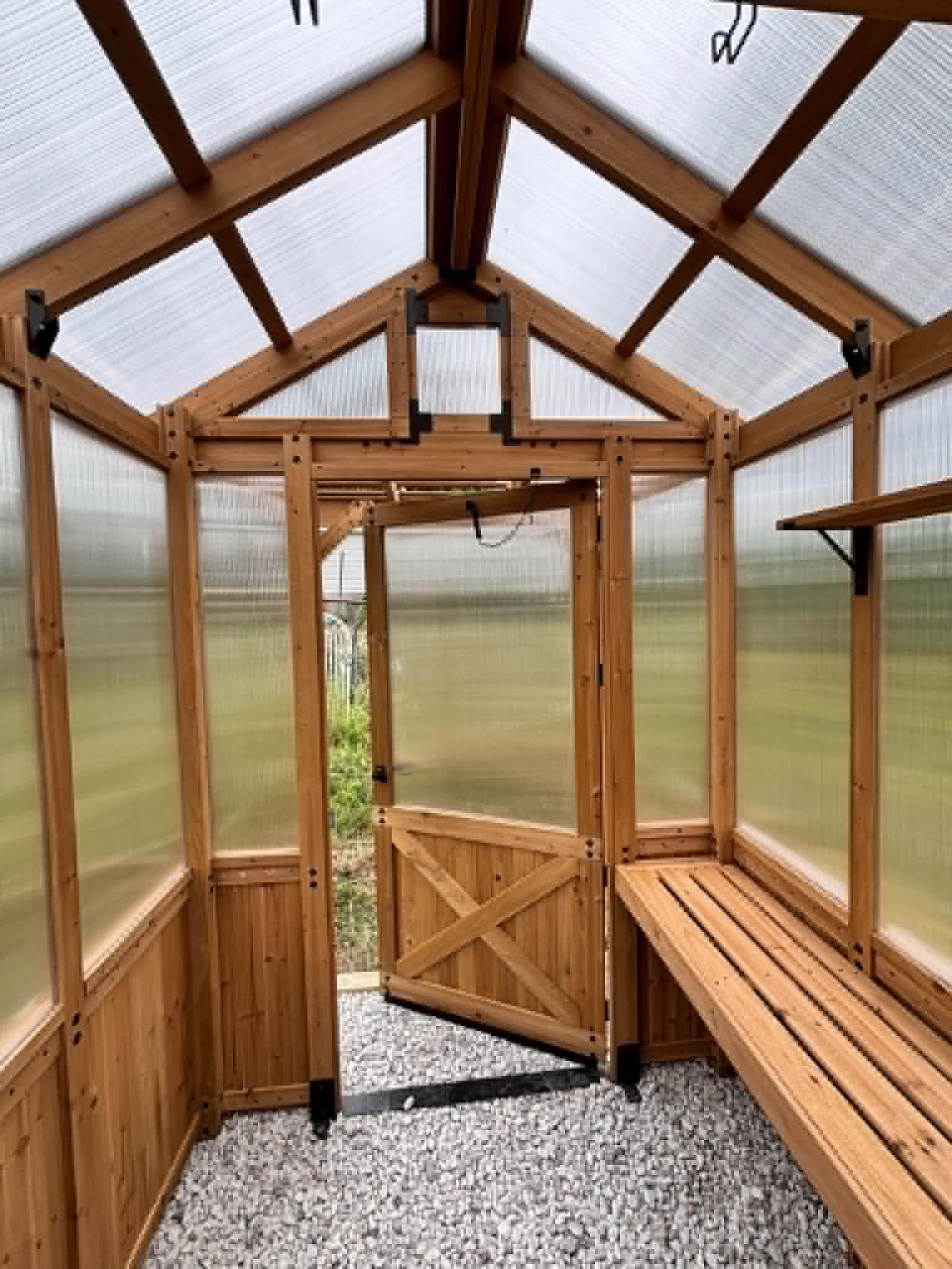 Interior view of custom cedar greenhouse built by Henning Construction in Middle Tennessee