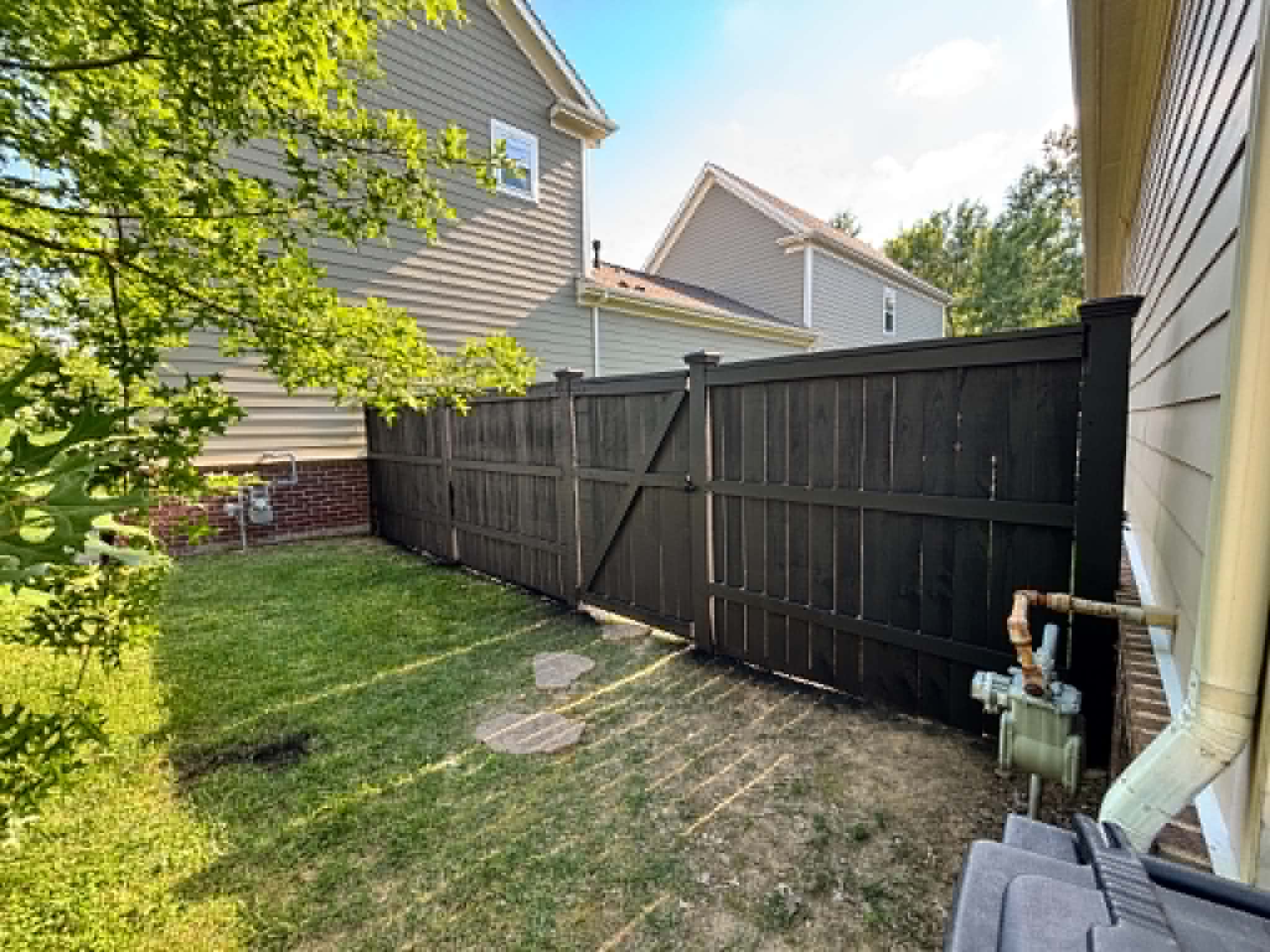 Grey privacy fence in suburban backyard by Henning Construction in Middle Tennessee