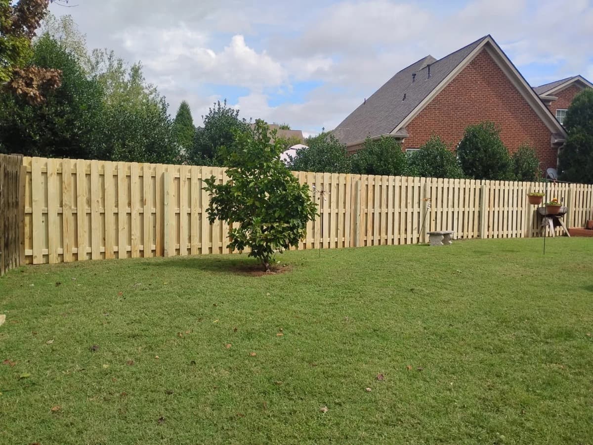 Shadowbox dog-ear privacy fence installed in suburban backyard, Middle Tennessee