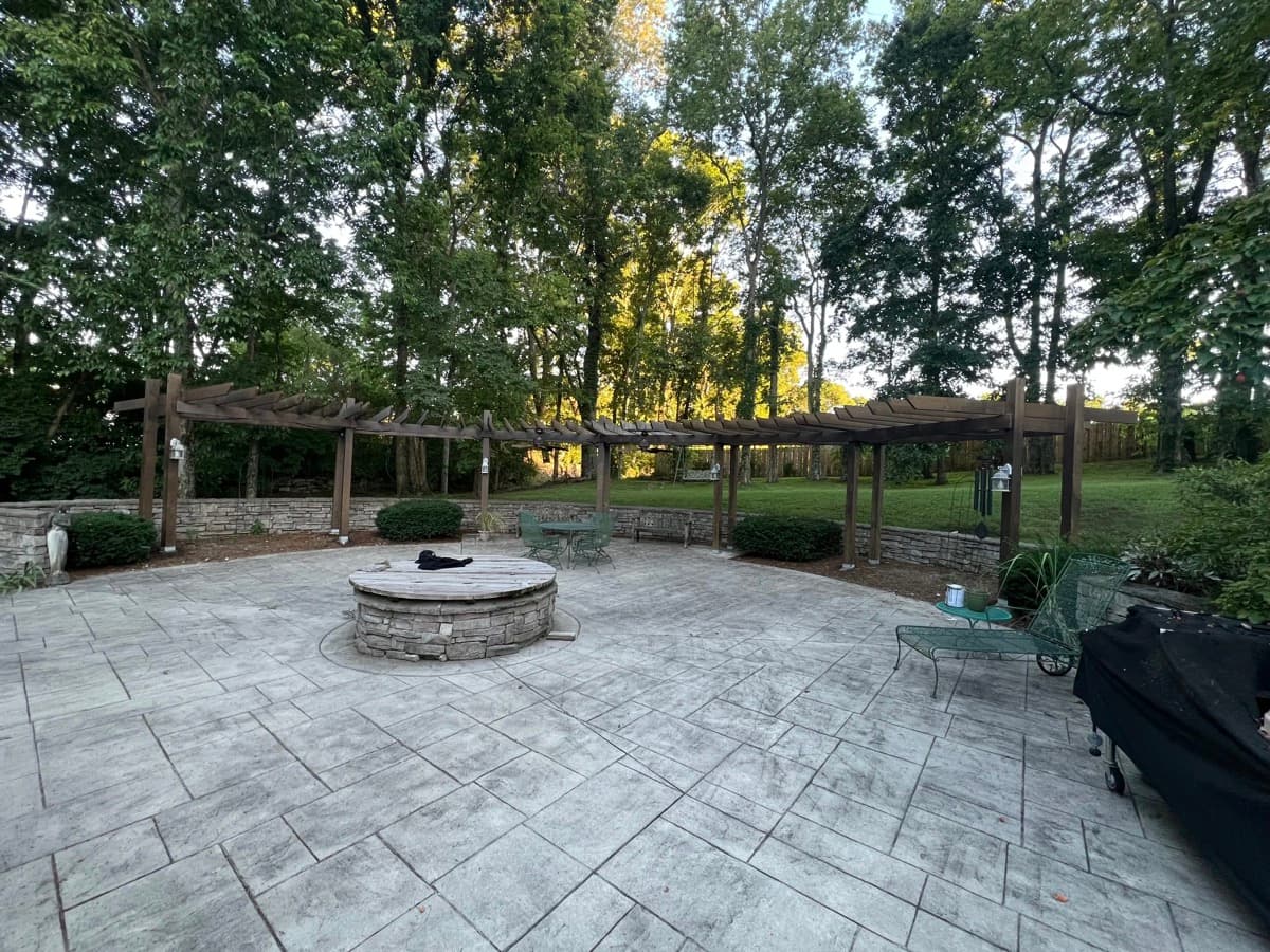Cedar pergola over stamped concrete patio with fire pit in Middle Tennessee